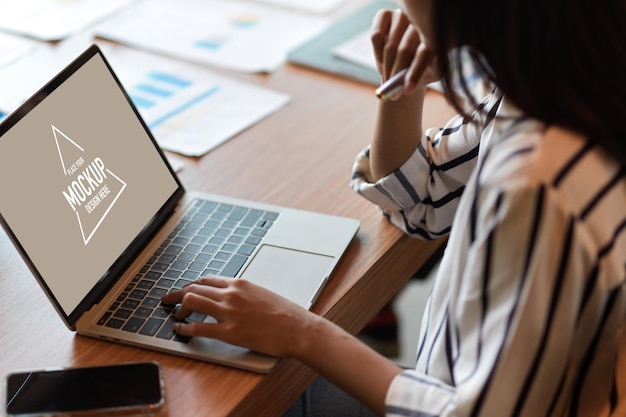 Cropped portrait of business female browsing on generic laptop with blank desktop screen at office