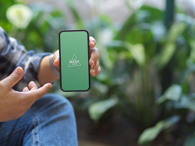 Cropped shot of a man showing mockup smartphone screen