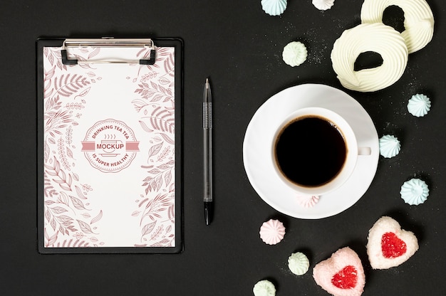 PSD cup of coffee and candies clipboard mock-up