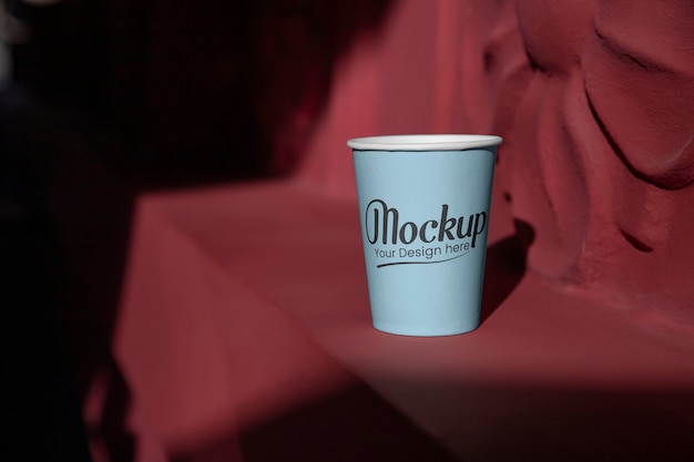 PSD cup mockup in public space