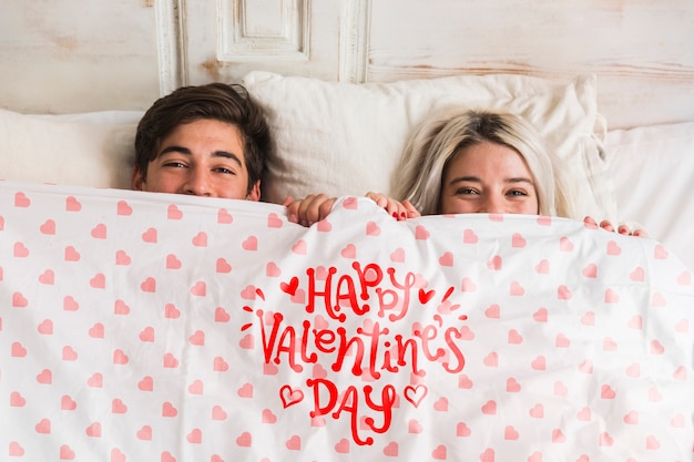 PSD cute young couple in bed for valentines day
