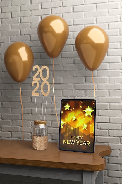 PSD decorations on table beside tablet with message for new year