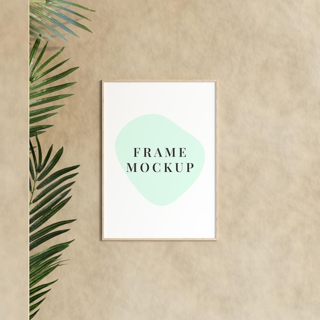 Decorative empty frame mockup hanging on the wall with plant in minimalist room