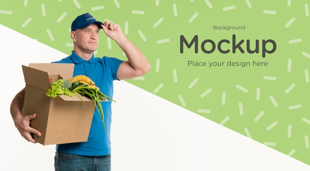 PSD delivery man holding a box of vegetables