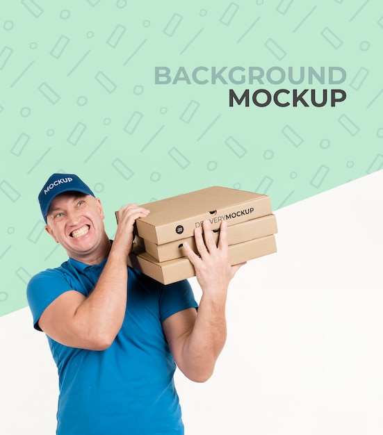 PSD delivery man holding boxes with pizza with background mock-up