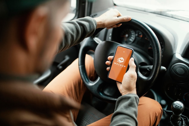 PSD delivery man holding phone mockup