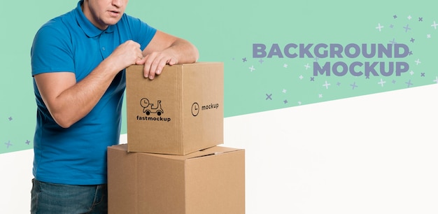 delivery man supporting himself on a bunch of boxes with background mock-up