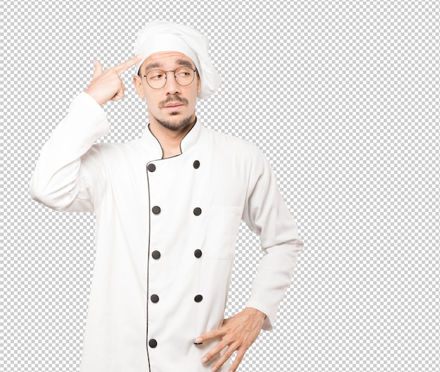 PSD depressed young chef making a suicide gesture