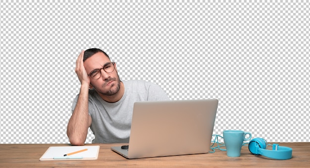 depressed young man sitting at his desk