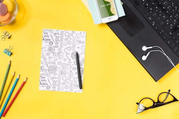 Desk concept with devices to take notes and paper sheets