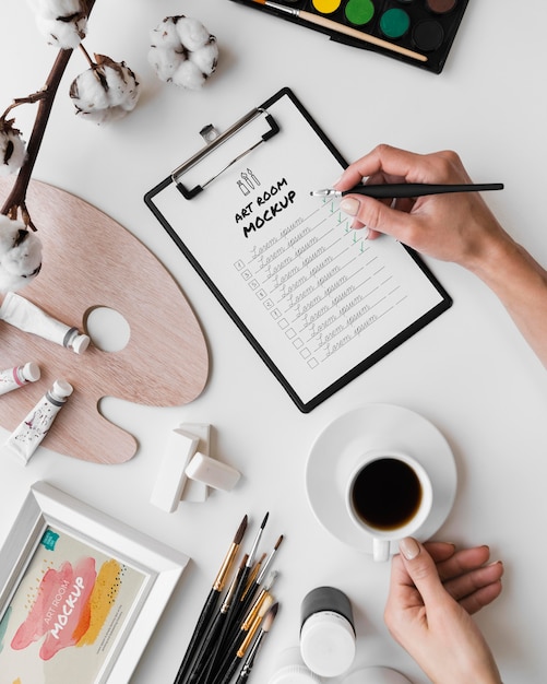 Desk of painting artist with clipboard