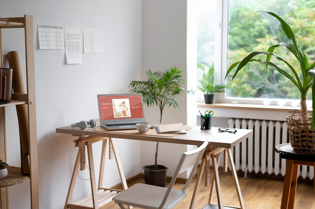 Desk with laptop and chair ready for home working