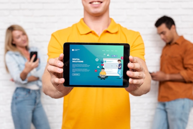 digital solutions text on tablet with defocused people in background