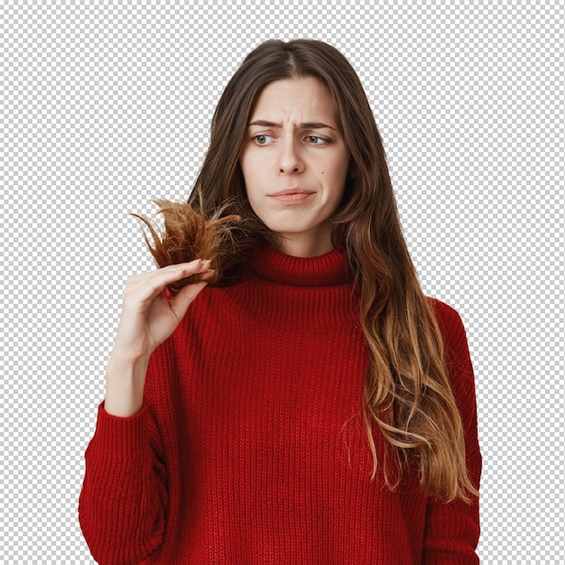 displeased woman looking at split ends of hair