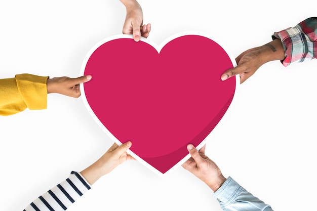 Diverse hands holding a red heart