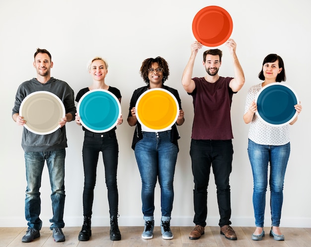 Diverse people holding blank round board