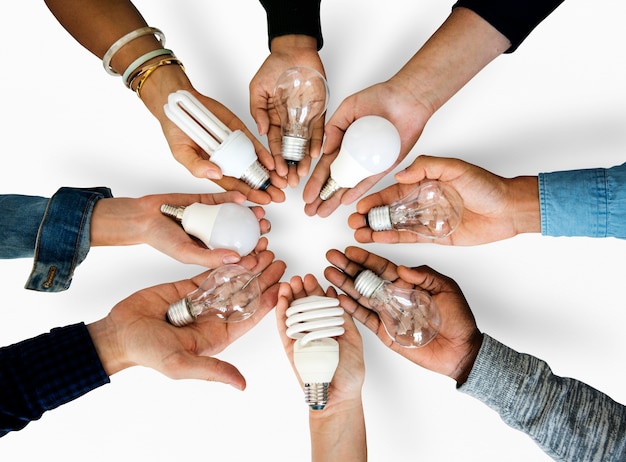 Diversity hands holding innovation lightbulb energy