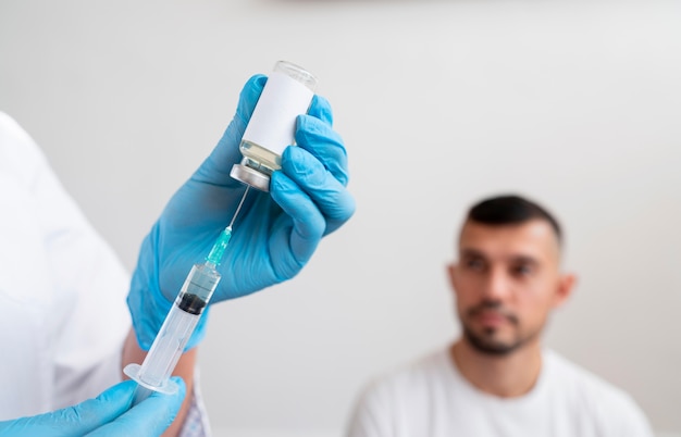 Doctor getting ready the vaccine for a patient