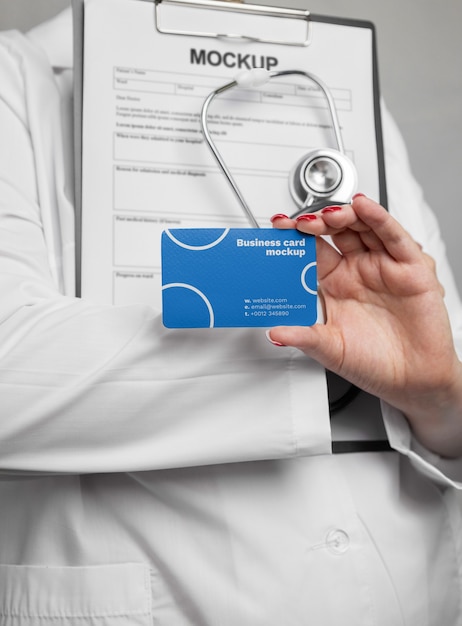 Doctor holding stethoscope and card front view