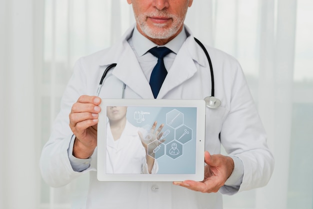 Doctor with stethoscope holding a tablet