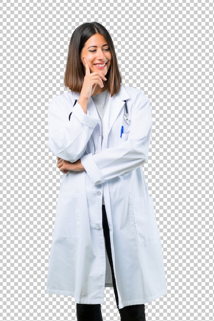 Doctor woman with stethoscope standing and looking to the side with the hand on the chin