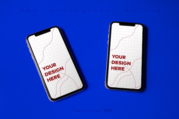 Double smartphone screen mockup above flat paper texture by real photography