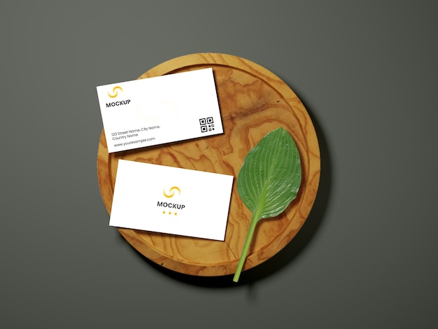 Doubleside of visiting card mockup with leaf over round wooden part