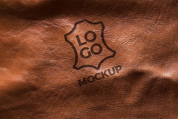 PSD dramatic warm light over leather logo mockup