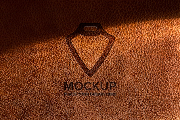 PSD dramatic warm light over leather logo mockup