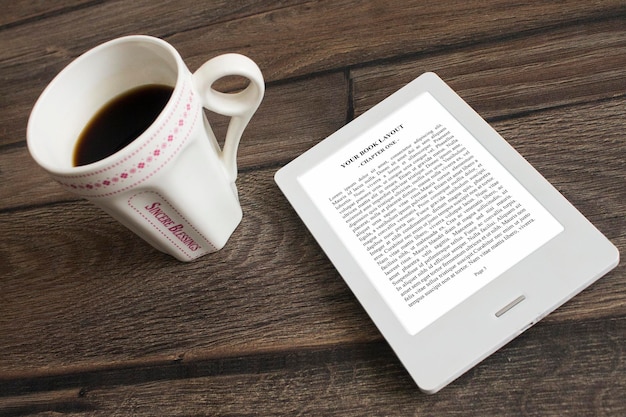 PSD e-book reader, mock up, reading with black cofee cup and white e-book reader