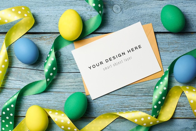 PSD easter holiday greeting card mockup with colored eggs and ribbons on wooden table