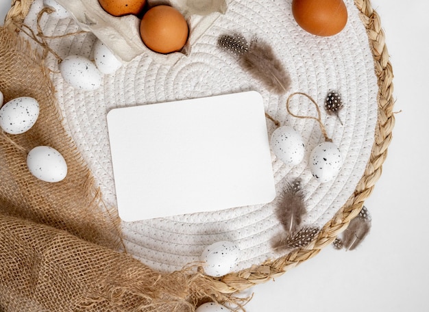 PSD easter mockup with traditional eggs feathers and trendy sack decor on table festive spring holiday template with greetings postcards with copy space