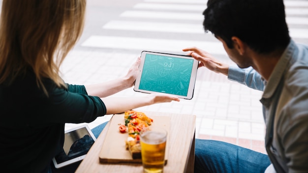 PSD eating couple in city with tablet