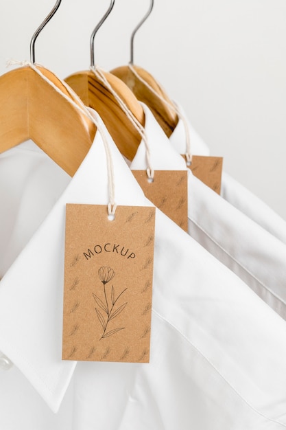 PSD eco-friendly price tags and formal shirts with hangers mock-up