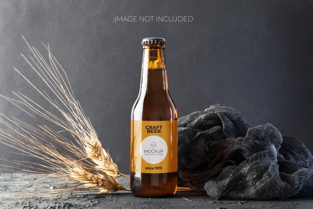 Elegant beer bottle model with ears of wheat on black background and rustic base