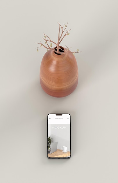 モックアップスマートフォンと花瓶でエレガントな構成