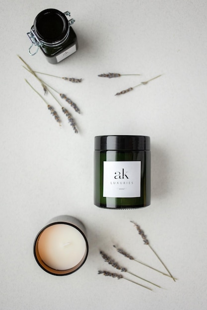 An elegant logo mockup on a white labeled candle jar