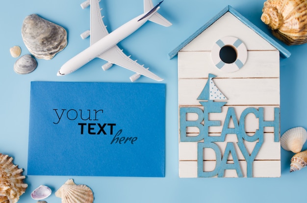 貝殻や装飾的な飛行機の空の青い紙。夏の旅行のコンセプトです。