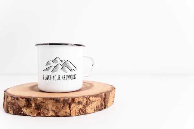 PSD enamel white mug on rustic wooden cut board mockup. boho style