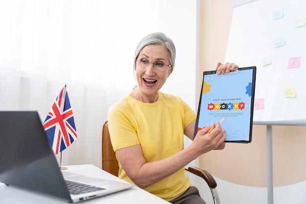 PSD english teacher holding a mock-up tablet