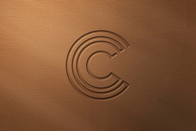 Engraved effect logo mockup on brown colored background