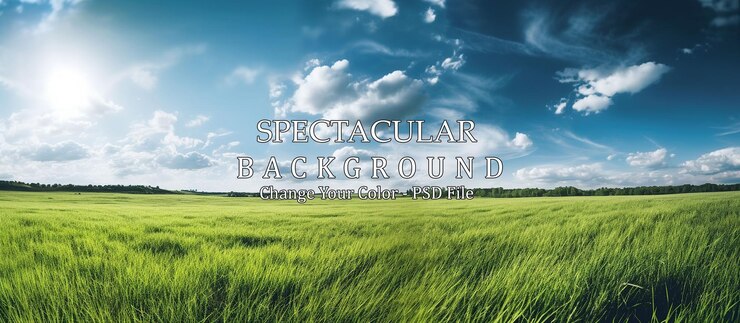PSD expansive green field under bright blue sky with fluffy clouds