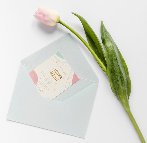 PSD fat lay of wedding card with envelope and tulip