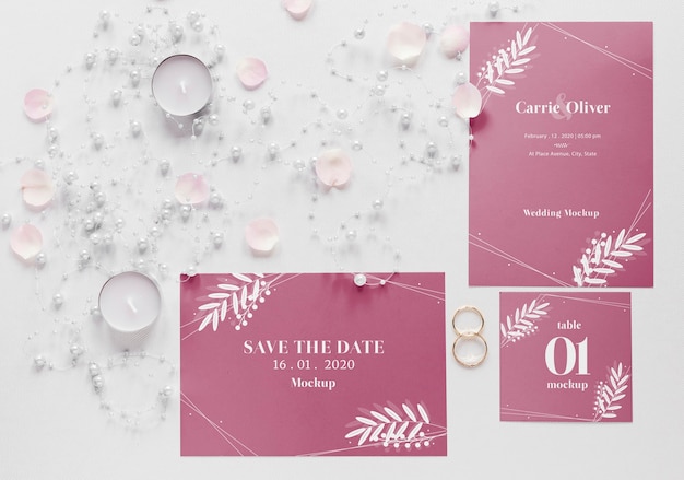 PSD fat lay of wedding cards with candles and rings