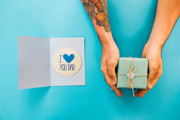 Fathers day mockup with card and hands holding present box