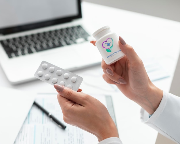 PSD female doctor holding a mock-up medicine bottle