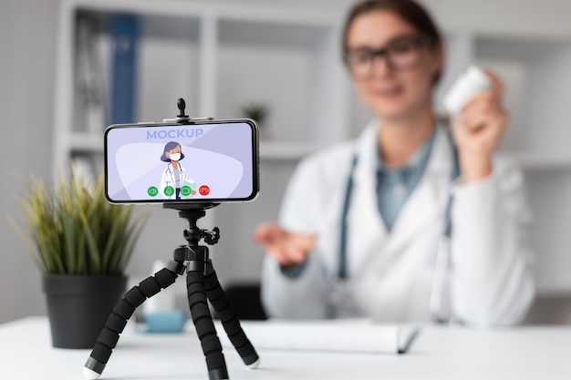 PSD female doctor holding a mock-up smartphone