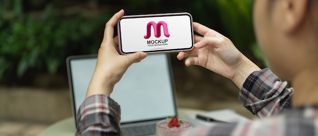 female freelancer relaxing with mockup smartphone
