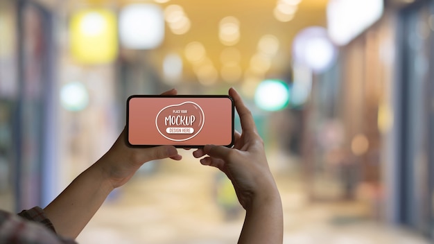 Female hands holding mock up smartphone screen