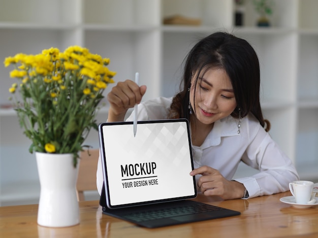 Female office worker presenting with tablet mockup